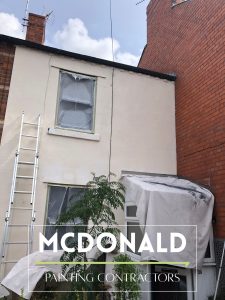 A white terraced house in Chester before being painted by McDonald Painting Contractors Ltd.